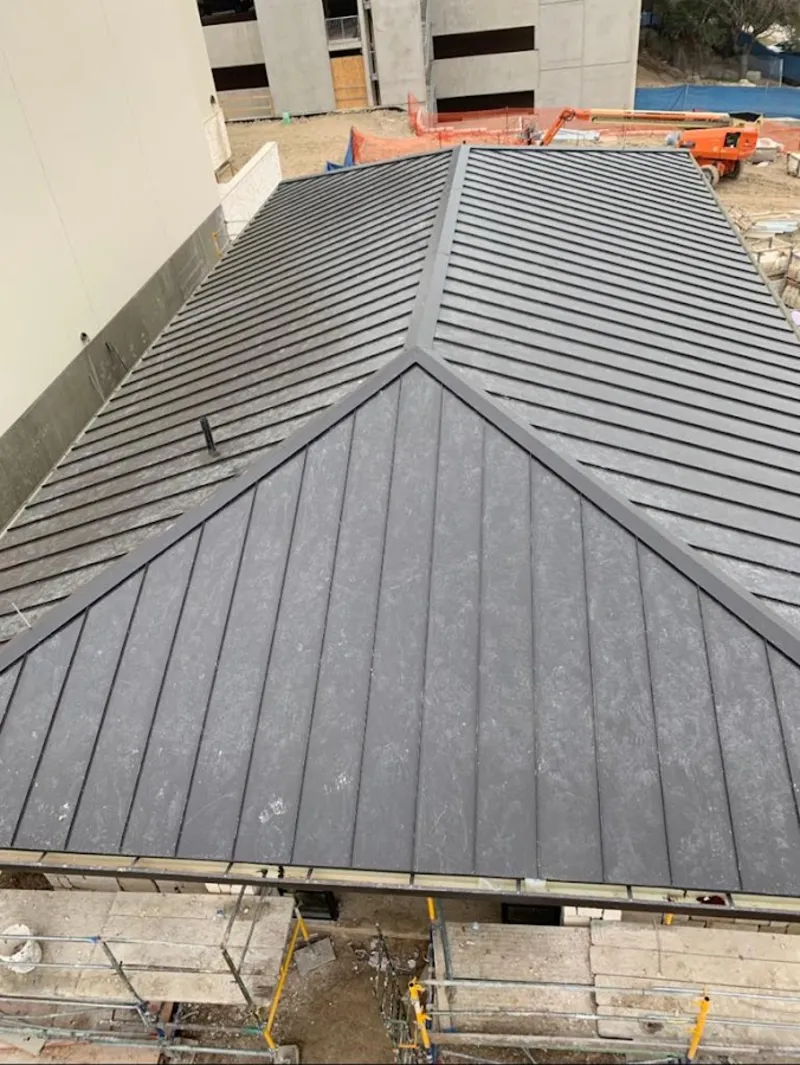 Commercial metal roof construction with crane equipment in Ferndale