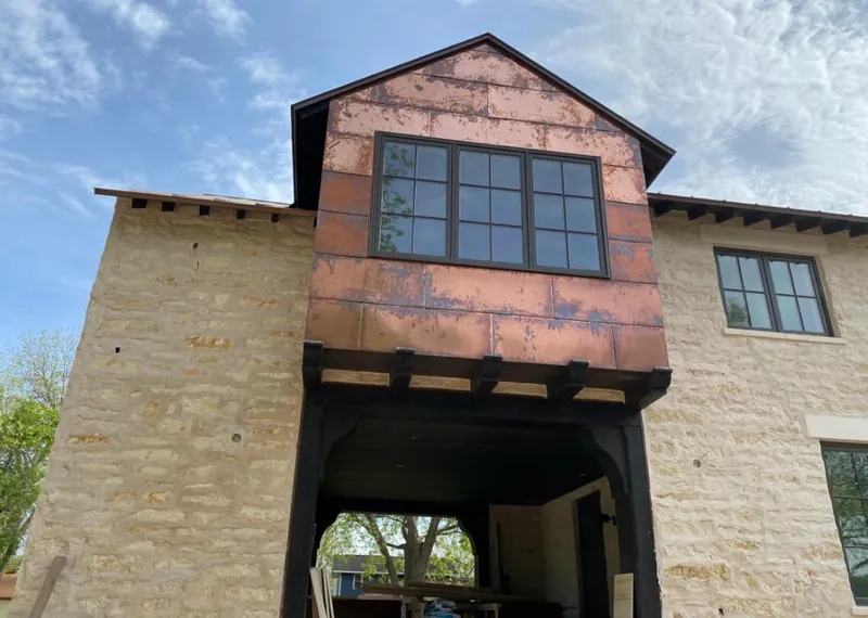 Copper metal panel facade on a stone building for Metal Roof Coating in Ferndale